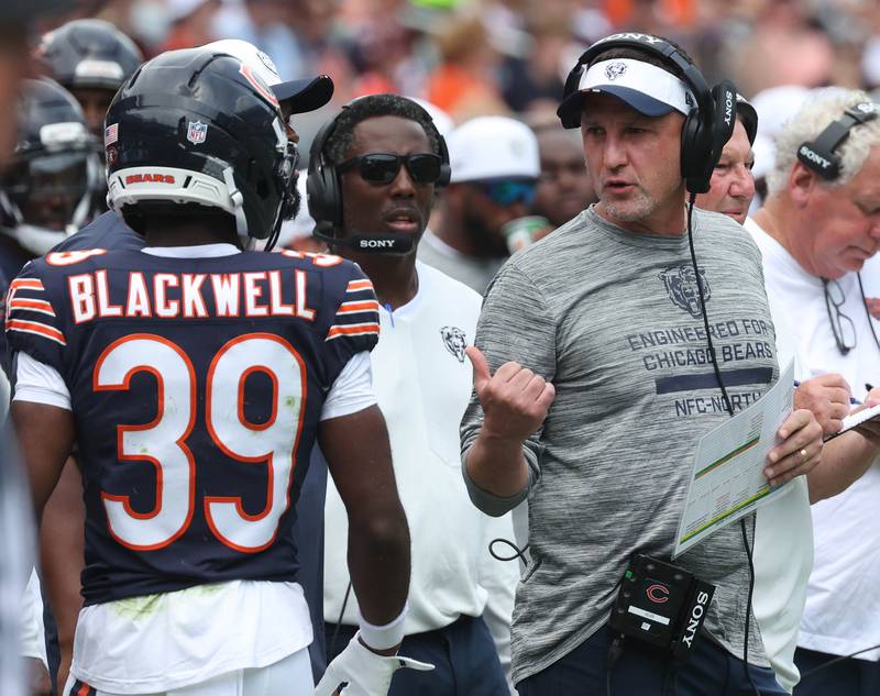 Chicago Bears defensive coordinator Dennis Allen talks to cornerback Josh Blackwell Sunday, Aug. 10, 2025, during their preseason game against the Miami Dolphins at Soldier Field in Chicago.