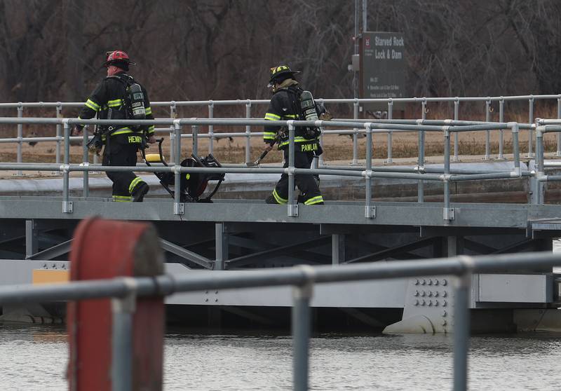 Utica firefighters Jodi Henry and Bonnie Pawlak exhaust fan across the gates to the Starved Rock Lock and Dam on Tuesday, Jan. 13, 2026 near Utica. A light haze of smoke was coming from inside the Peru Hydroelectric Power Plant.  Fire departments from Tonica, La Salle, Wallace, Tonica, Peru and Utica all responded to the scene. The incident happened shortly before 2:30p.m. No injuries were reported.