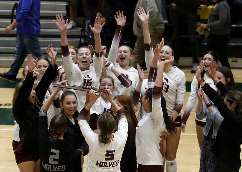 Prairie Ridge's Allison Rodgers and Grace Jansen raise the trophy after they defeated Crystal Lake South in  the IHSA Class 3A Crystal Lake South Sectional final volleyball match on Thursday, Nov. 7, 2024, at Crystal Lake South High School.