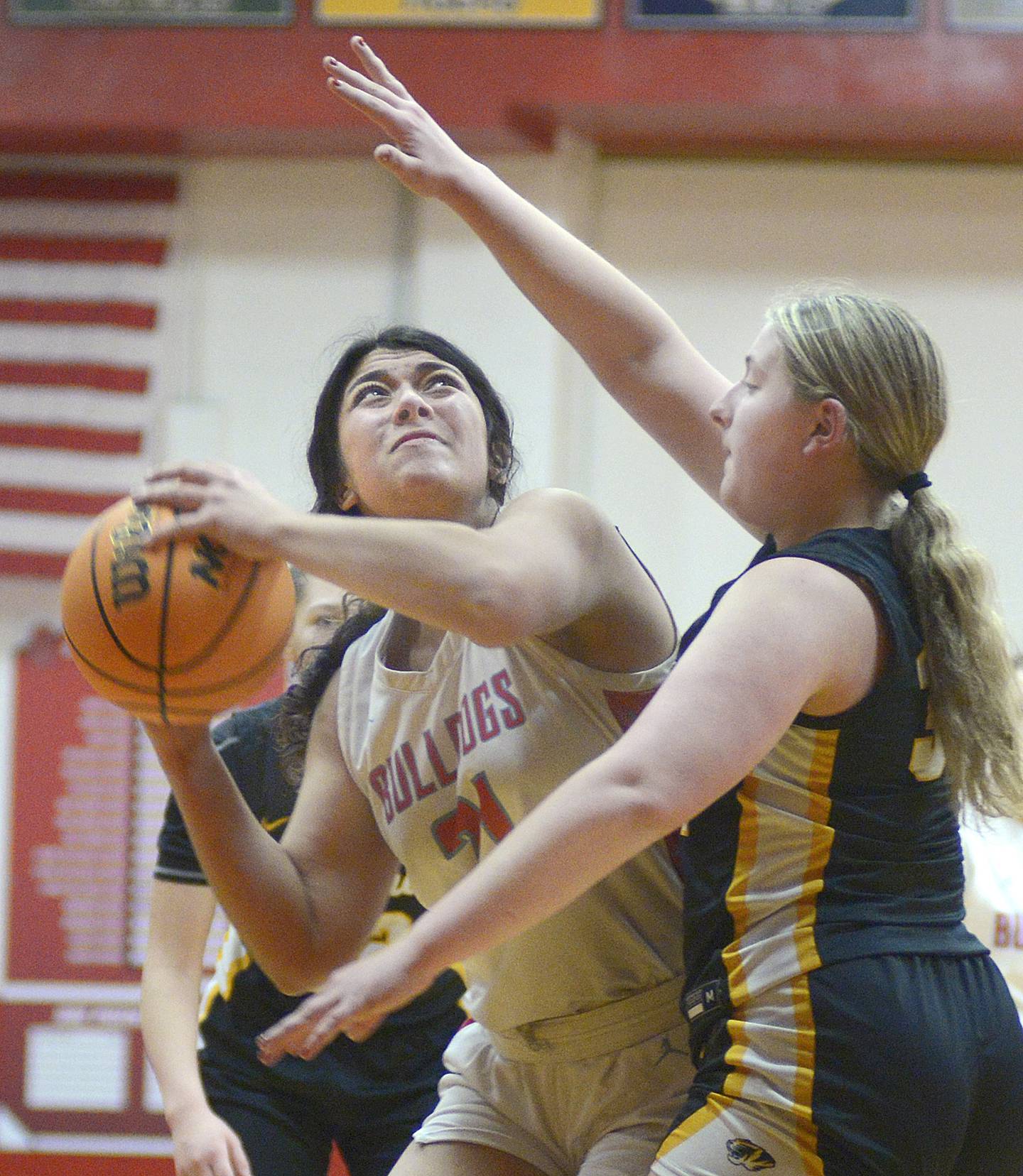 Streator’s Alexis Thomas works to get this shot past the block of Herscher’s Abygale Coutant n the 1st period Tuesday at Streator.