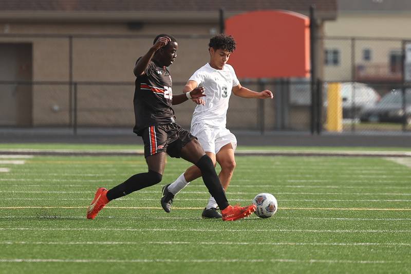 Plainfield East’s Kevin Tchoffa kicks away the ball from Plainfield Central’s Elijah Rodriguez on Tuesday, Sept. 19, in Plainfield.