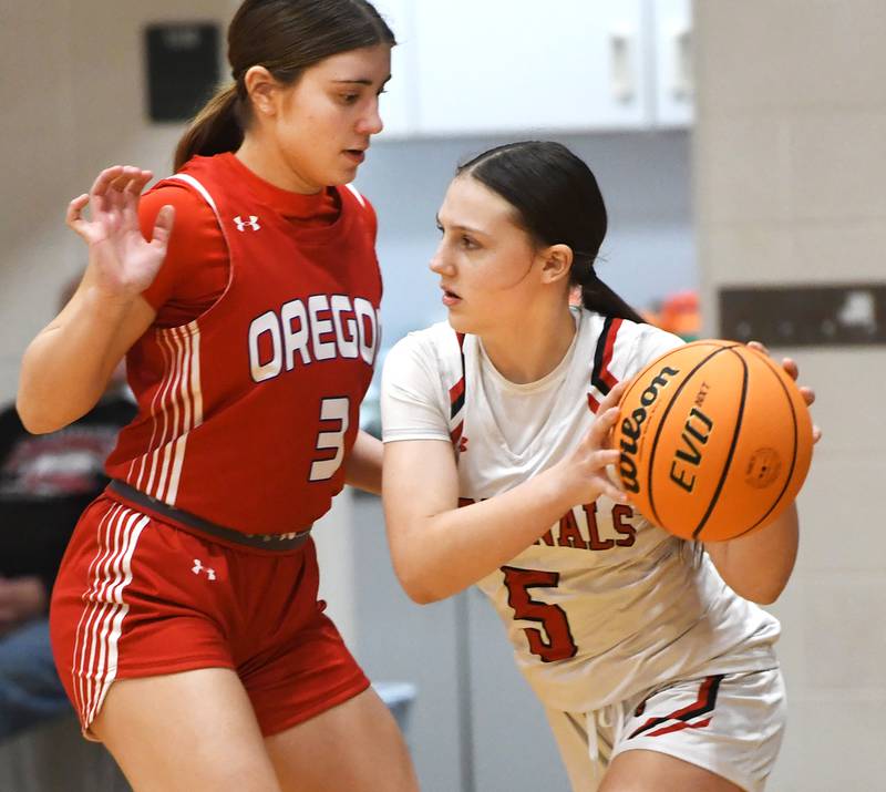 Forreston's Xairyn Goeddeke (5) looks to pass as Oregon's Lola Schwarz (3) defends during a Saturday, Jan. 3, 2026 game at Forreston High School.