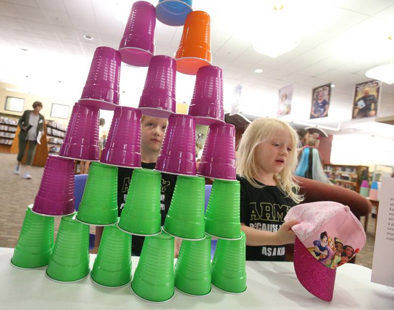 Addalye and Josalyn Edwards of Pinckneyville, enjoy stacking cups while playing the "stack attack" game on Friday, June 20, 2025 at the Princeton Public Library.