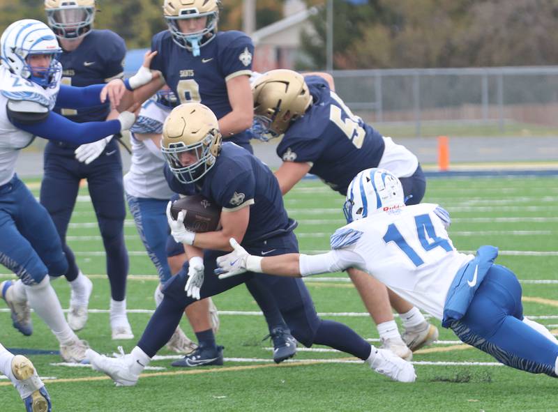 Princeton's Jack Oester (right) falls to the turn while trying to tackle Central Catholic's Connor Rave during the Class 3A playoffs on Saturday, Nov. 1, 2025 at Central Catholic High School in Bloomington.
