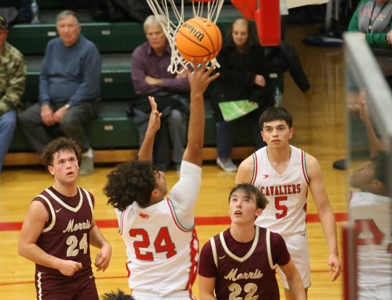 L-P's Marion Persich lets go of the ball under the net as Morris's Colin Pfeifer and Brett Bounds defend on Friday, Dec. 6, 2024 in Sellett Gymnasium at L-P High School.