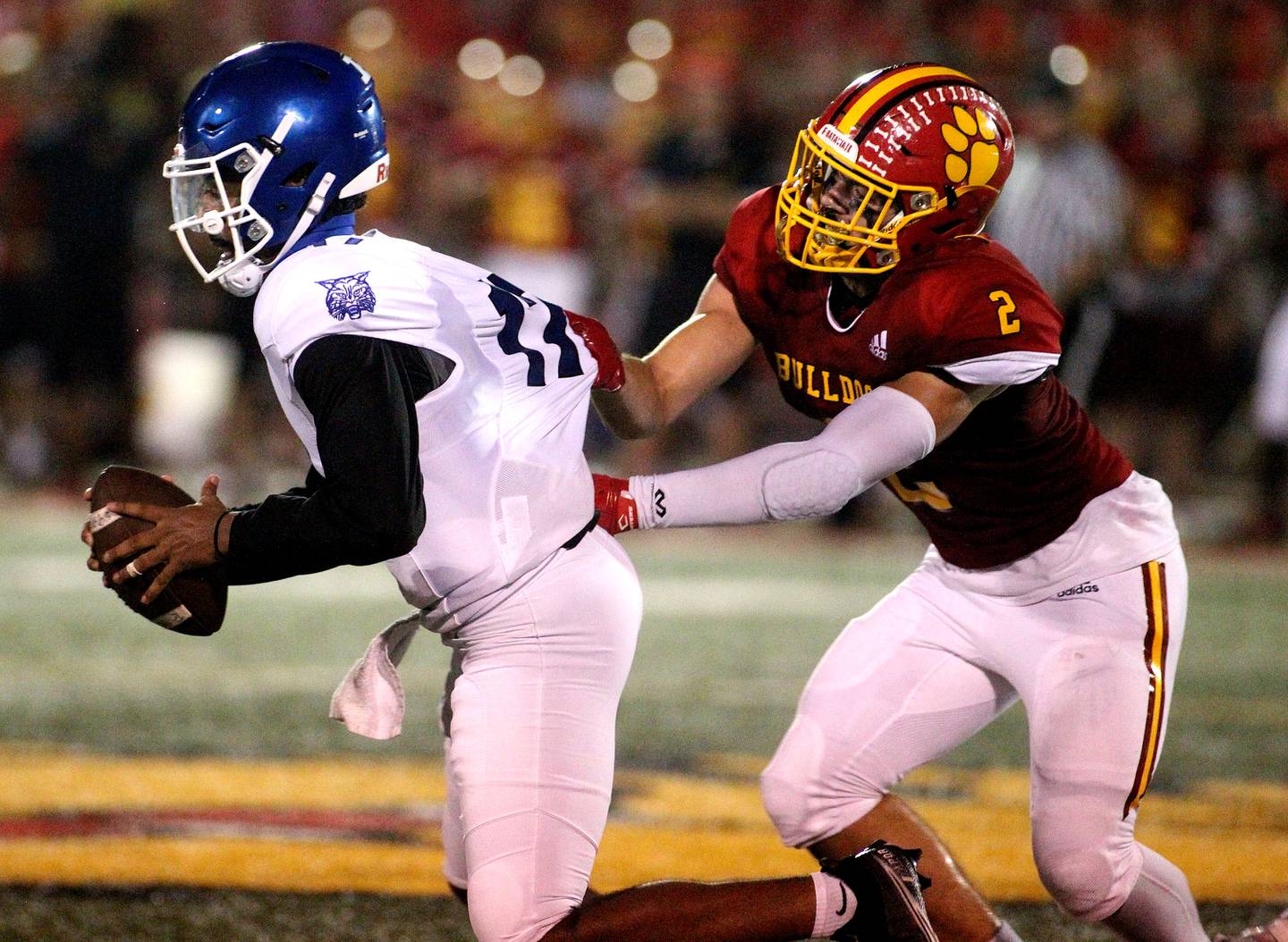 Batavia's Drew Bartels (2) tries to take down Phillips quarterback Tyler Turner during the first game of the season in Batavia on Friday, Aug. 27, 2021.