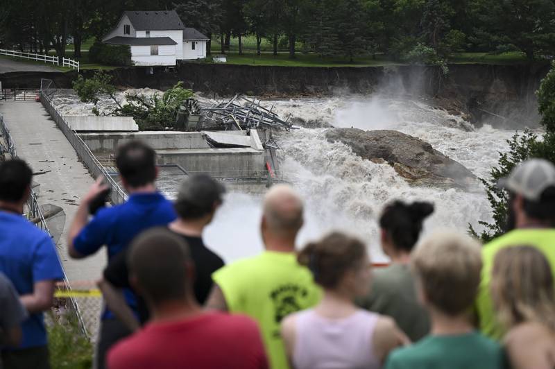 A home teeters on the brink of collapsing into the Blue Earth River on Monday, June 24, 2024, near the Rapidan Dam in Mankato, Minn. (Aaron Lavinsky/Star Tribune via AP)