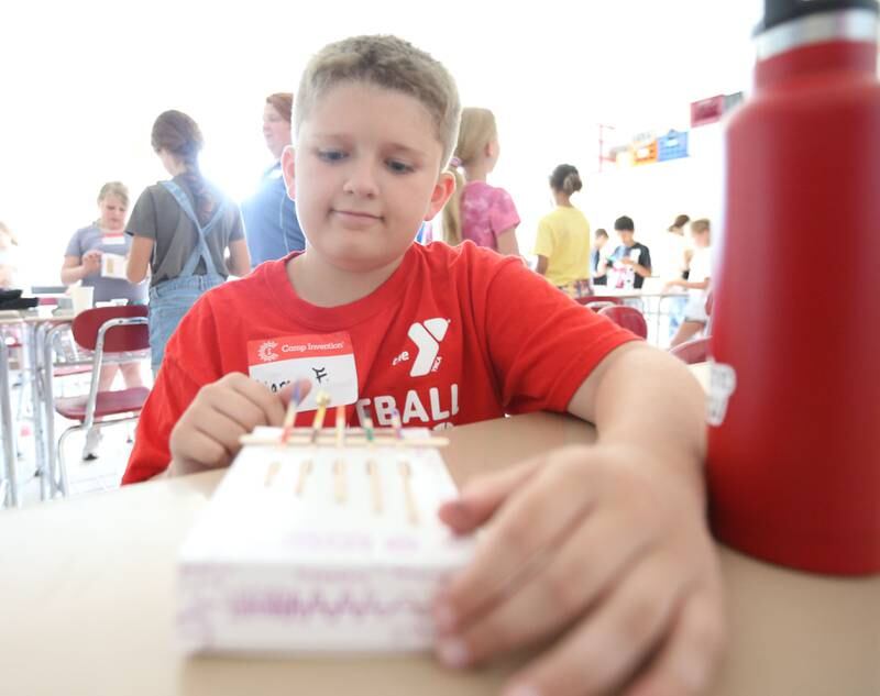 Liam F. plays a song on his instrument that he made during Camp Invention at Central Intermediate School on Thursday, June 15, 2023 in Ottawa. Exploring nature, genetics and adaptive innovation, kids turned a MimicBot into a one-of-a-kind animatronic stuffie.