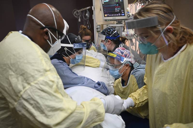 Critical care nurses and respiratory therapists flip a COVID-19 patient upright in North Memorial's South Six and South Seven Intensive Care Units