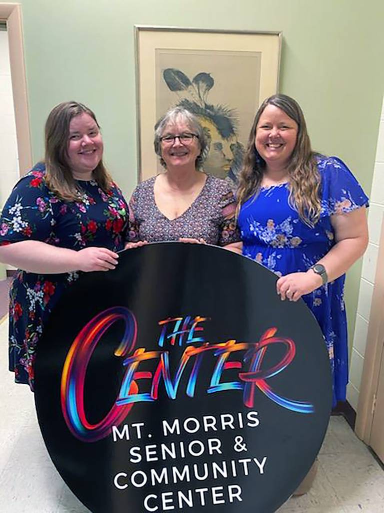 Erica Nicholson, Cindy Nicholson and Mt. Morris Senior & Community Center Executive Director Melissa Rojas set up together for the Center's April 30, 2024, open house.