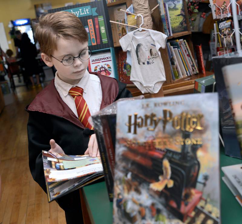 Sam Girard checks out some of the Harry Potter books while donning his best Harry Potter look Saturday, July 29, 2023, at Prairie Fox Books in Ottawa during the fifth annual Harry Potter Birthday Bash.