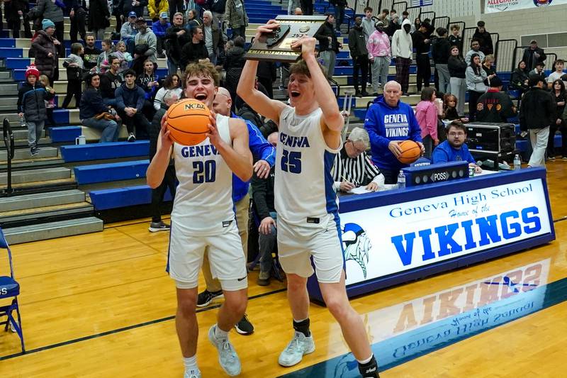 Geneva’s Jack Hatton (20) holds the game ball while Hudson Kirby (25) raises the regional class 4A championship plaque in celebration after defeating Glenbard North to win the class 4A Geneva regional final at Geneva High School on Friday, Feb. 28, 2025.