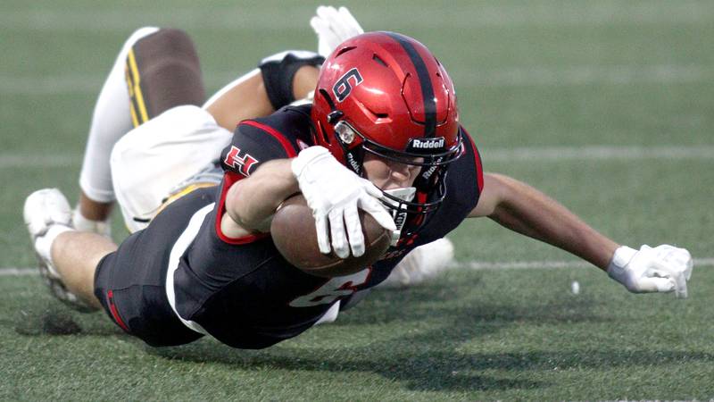 Huntley’s Jacob Witt dives for a first down against Jacobs in varsity football in Huntley Friday night.