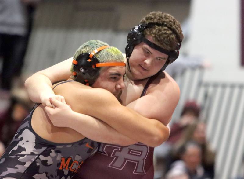 McHenry’s Marc Walsh, left, battles Prairie Ridge’s Bernardo Tavares Vigilato at 285 pounds in varsity boys wrestling on Thursday, Jan. 8, 2026 at Prairie Ridge High School in Crystal Lake.