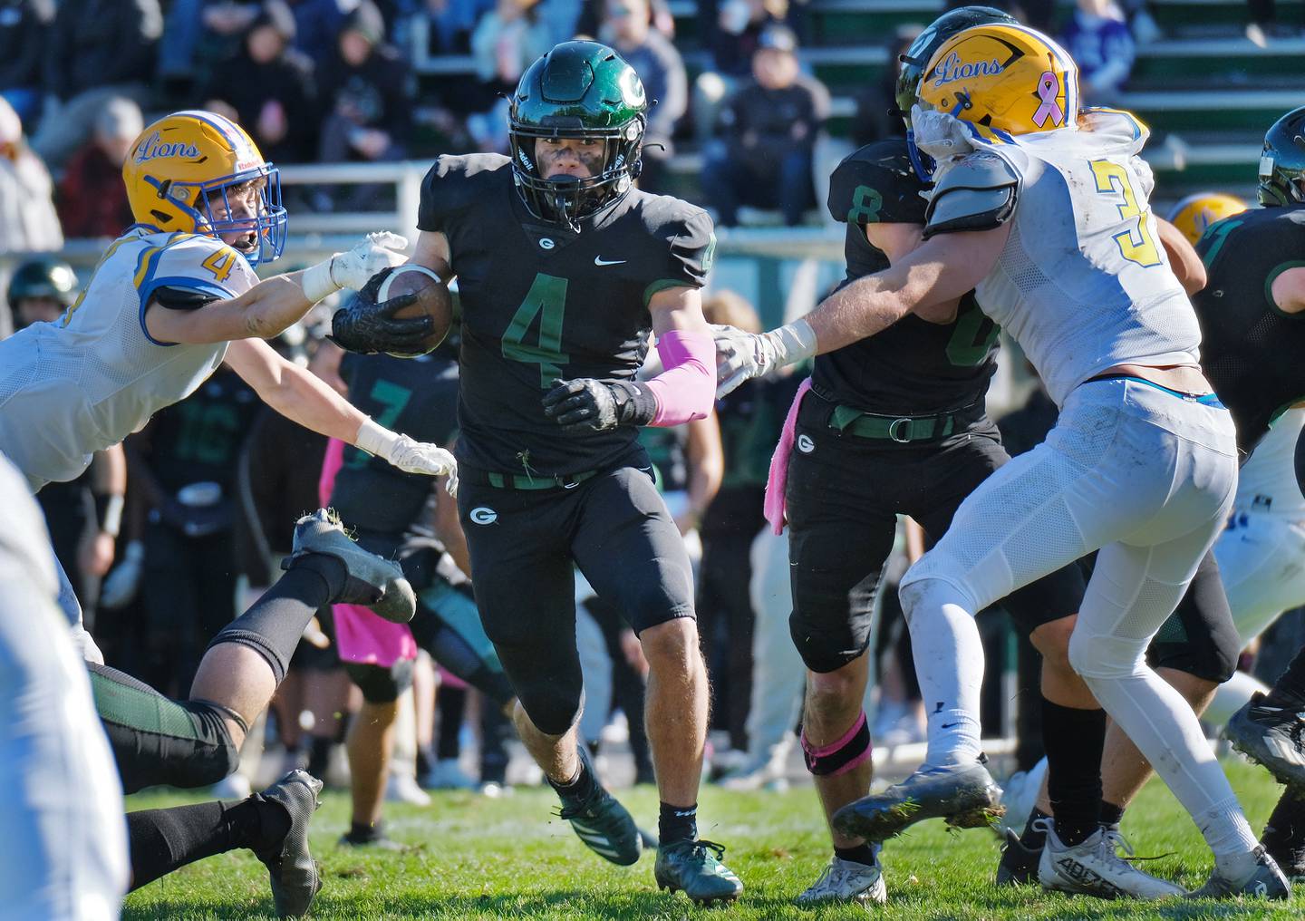 Glenbard West's Julius Ellens (4) breaks through a hole in the Lyons Township defense during a game on Oct. 15, 2022 at Glenbard West High School in Glen Ellyn.