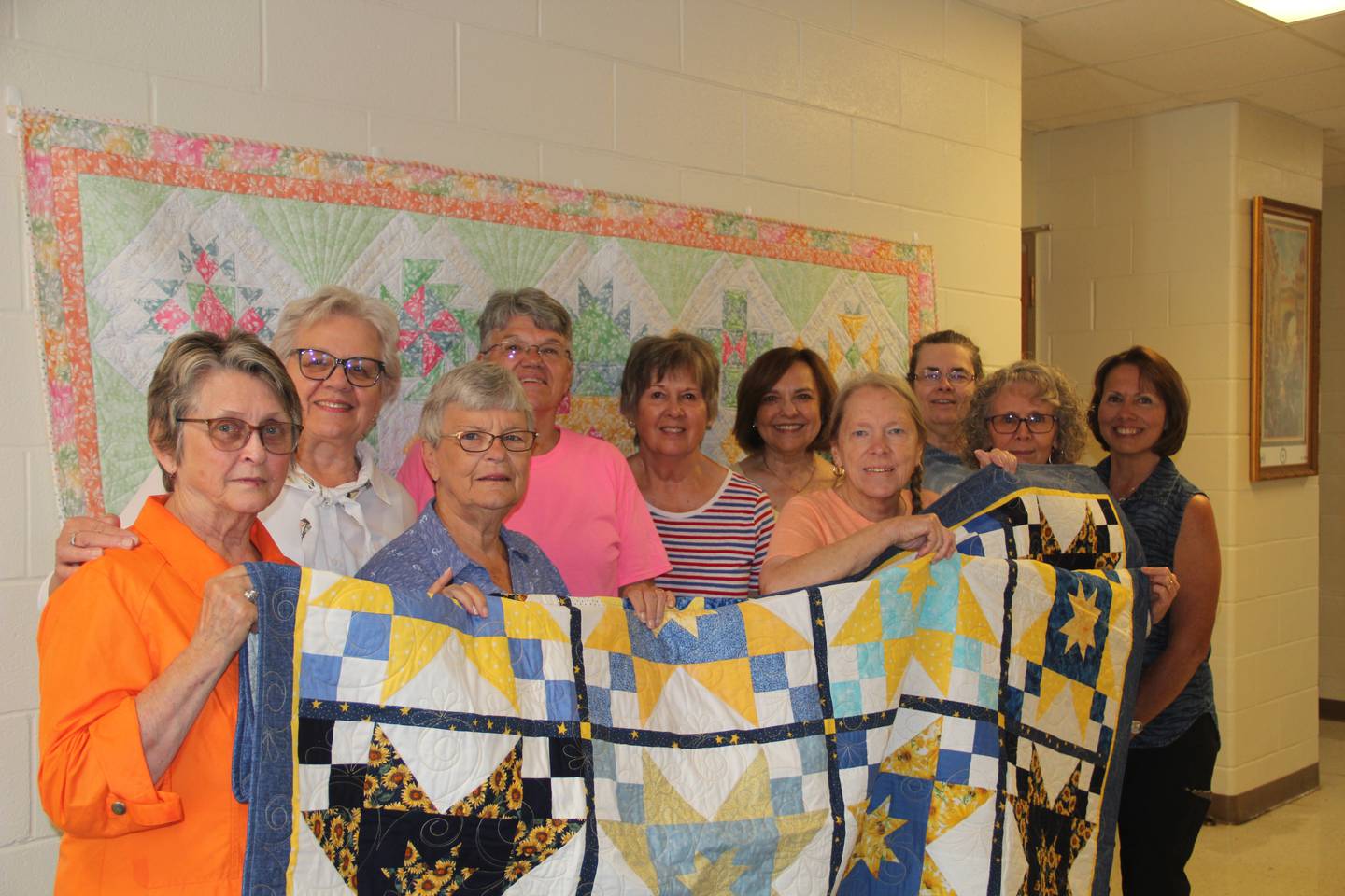 Quilters created a pair of quilts they plan to raffle to raise money for St. Jude in support of Ukrainian pediatric cancer patients. They are (front, left to right) Judy Barickman, Phyllis Maddux, Mary Harrison, Patty Winkler and Becky Berry (back, left to right) Toni Miles, Susie Bedeker, Cindy Hart, Marge Fulton and Pam Riss. Not pictured are Joy Ahearn, Nikki Clark, Pat Durdan, Mary Jo Hiltabrand and Mary Lentman.
