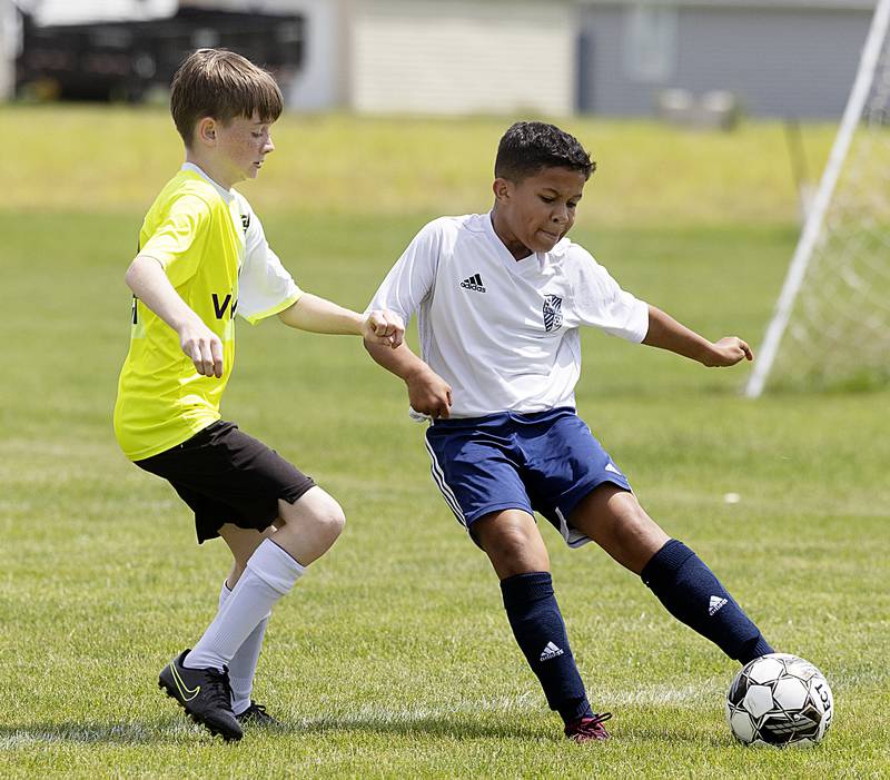 Sterling United’s Jaden Miller (right) works against a Quad City Strikers player Sunday, May 19, 2024 at Scheid Park in Sterling.