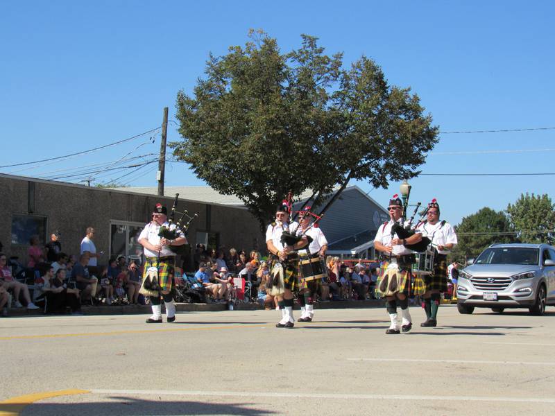 The Medina Highlanders play the bagpipes during the Grundy County Corn Festival parade on Sunday.