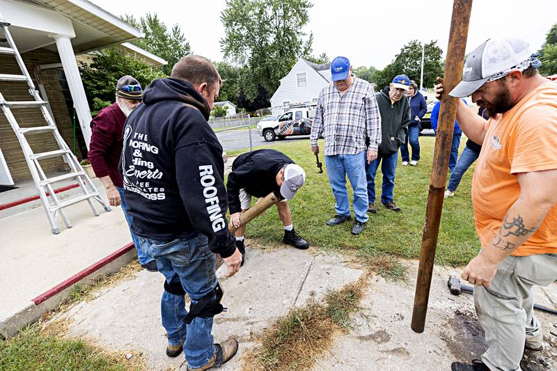 Joel Wiseman, son of a former pastor of the Lincoln Ave. Church of God peers into the pipe Wednesday, Sept. 13, 2023 in search of a time capsule.
