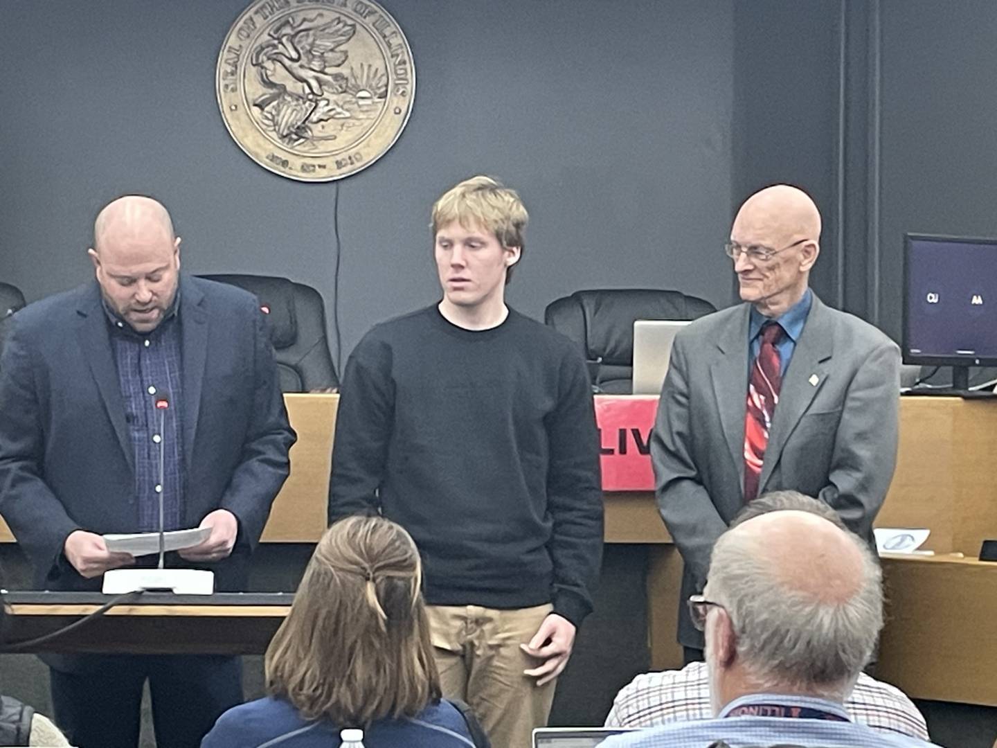 Griffin Cook (center), a senior at Earlville High School, and La Salle County Board Chairman Don Jensen (right) listen while Regional Superintendent of Schools Chris Dvorak (left) summarizes Cook's academic accomplishments Thursday, Feb. 8, 2024, at the county board meeting in Ottawa. Cook, son of Matt and Sarah Cook, is Earlville High's class president and high honor roll student who plays varsity soccer, basketball and baseball. He is one of two winners of the county's Student Excellence Award for February.