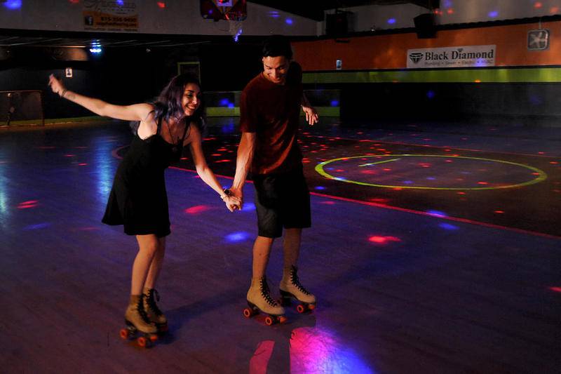 Angelo Grady helps his fiancée, Tiffany Glatt, keep her balance as they skate Friday, July 24, 2020, during a date at the Just For Fun Roller Rink in McHenry. The roller rink that was built in the early 1920s will be closing in September. The couple, who live near the rink, had wanted to come the rink to skate before the COVID-19 pandemic started, but when they found out the rink was closing the made a point to come skate.