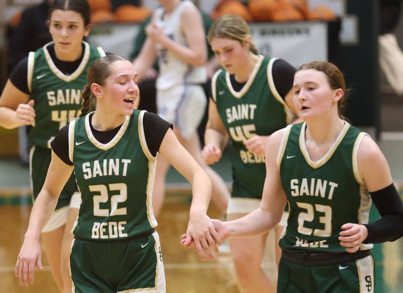 St. Bede's Hannah Heiberger hi-fives St. Bede's Lili McClain after defeating Princeton during the Class 2A Regional semifinal game on Tuesday, Feb. 17, 2026 at St. Bede Academy.