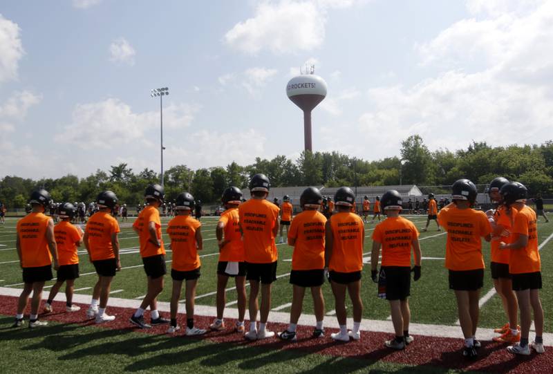 Crystal Lake Central football players watch there team practice during a 7 on 7 football practice Monday, July 14, 2025, at Richmond-Burton High School, with teams from Richmond-Burton, Grayslake Central and Mundelein.