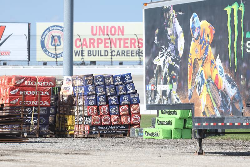 Track barriers are unloaded from a trail for the motocross course at the Chicagoland Speedway as crew setup for Saturday’s SuperMotocross World Championship Finals in Joliet.
