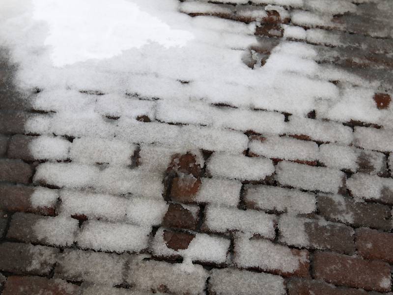Footprints in the snow on Thursday, Feb. 16, 2023, near the historic Woodstock Square, after a winter storm moved through McHenry County creating hazardous driving conditions.