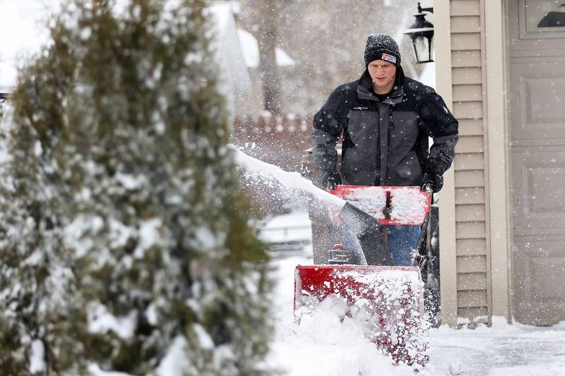 David Petrovich of Huntley uses a snowblower to clear his property on Tuesday, Jan. 26, 2021 in Huntley.