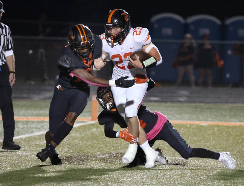 Lincoln-Way West's Jimmy Talley Jr. runs past two DeKalb defenders for a touchdown during their game Friday, Oct. 3, 2025, at DeKalb High School.
