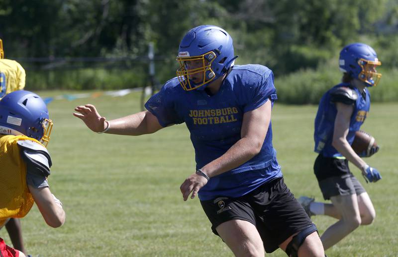 Jacob Welch prepares to block as he protects the runner during summer football practice Thursday, June 23, 2022, at Johnsburg High School in Johnsburg.