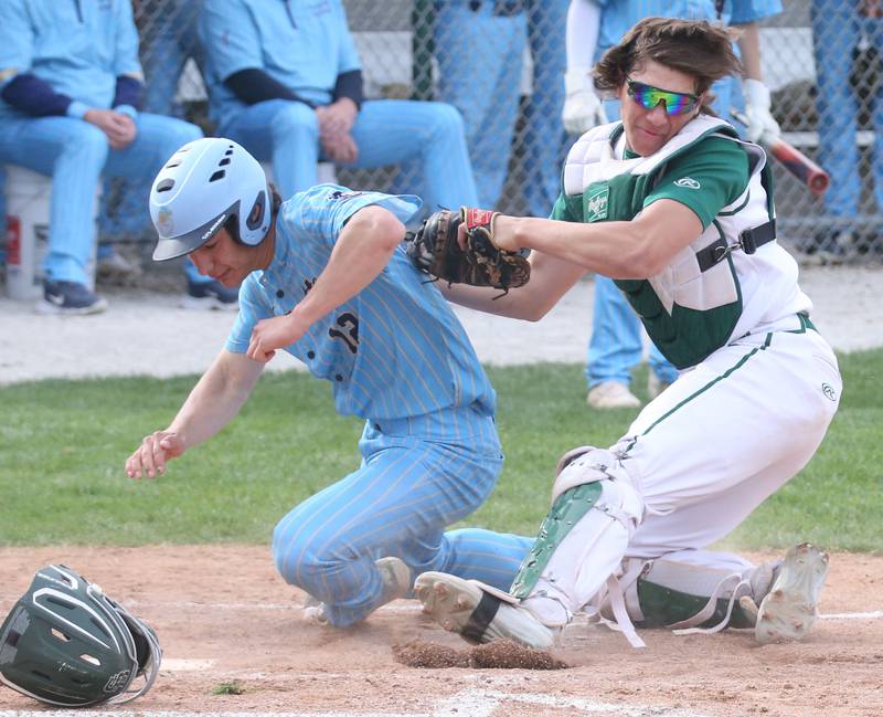Marquette's Payton Guttierez is tagged out by St. Bede catcher Nathan Husser at home plate on Monday, April 22, 2024 at St. Bede Academy.