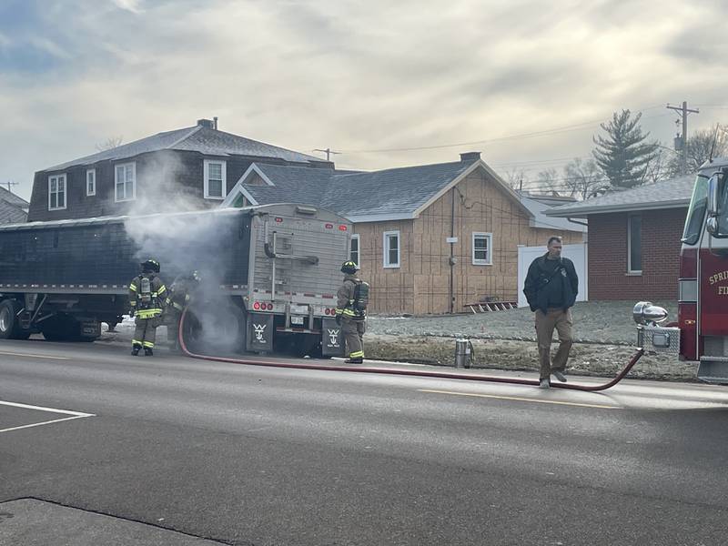 Spring Valley firefighters spray down a semi carrying soybeans Monday, Jan. 9, 2023, in the 200 block of West Dakota Street. Fire Chief Todd Bogatitus said the load caught fire and was extinguished, but the load still was hot and in danger of re-igniting.