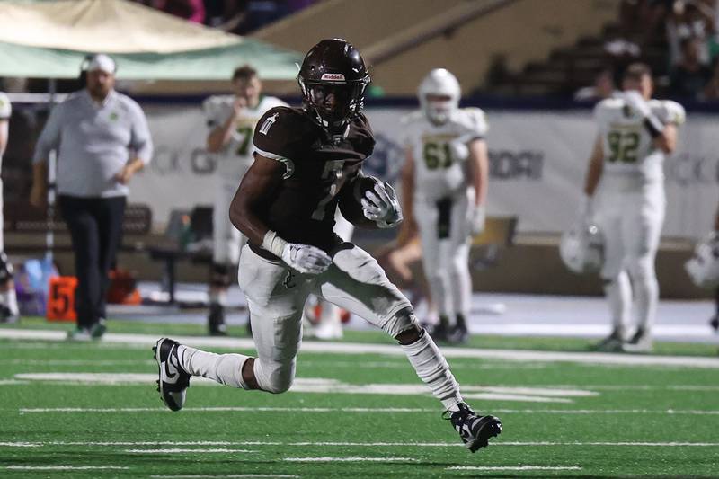 Joliet Catholic’s HJ Grigsby finds open field for a first down run against Providence on Friday, Sept. 1, 2023 Joliet Memorial Stadium.