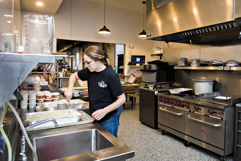 Taylor Troutman, server at Curate in Dixon, dishes up mac and cheese for workers at KSB Hospital in Dixon. Through the efforts of city Councilwoman Mary Oros, local businesses have come together to help feed workers at the hospital for lunch or dinner.