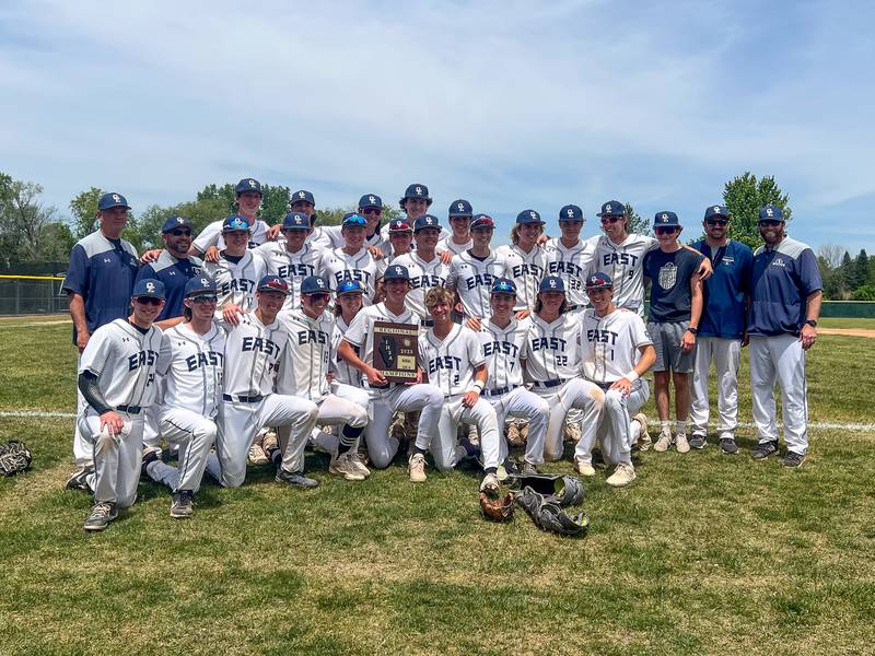 Oswego East players and coaches pose for photos with the 4A championship plaque after defeating Waubonsie Valley for the Class 4A Waubonsie Valley regional championship at Waubonsie Valley High School in Aurora on Saturday, May 27, 2023.