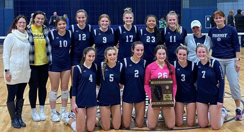 The Fieldcrest volleyball team and coaches pose with the Class 2A Fieldcrest Regional championship plaque after defeating Tri-Valley, 25-21, 26-24 on Thursday evening in Minonk.