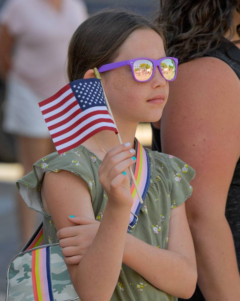 Maggie Schumacher, 9 of St. Charles waves an American Flag during Memorial Day Parade on Monday, May 29, 2023.
