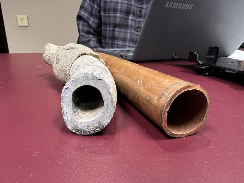 First Ward Alderman Alan Bauer displayed part of a lead service line he had replaced on his home years before the city of Sycamore offered the current lead service line replacement program, which allows residence to replace lead service lines at no cost to them, during the Oct. 16, 2023 Sycamore City Council meeting. On the right is a copper water service line, commonly used to replace lead service lines.