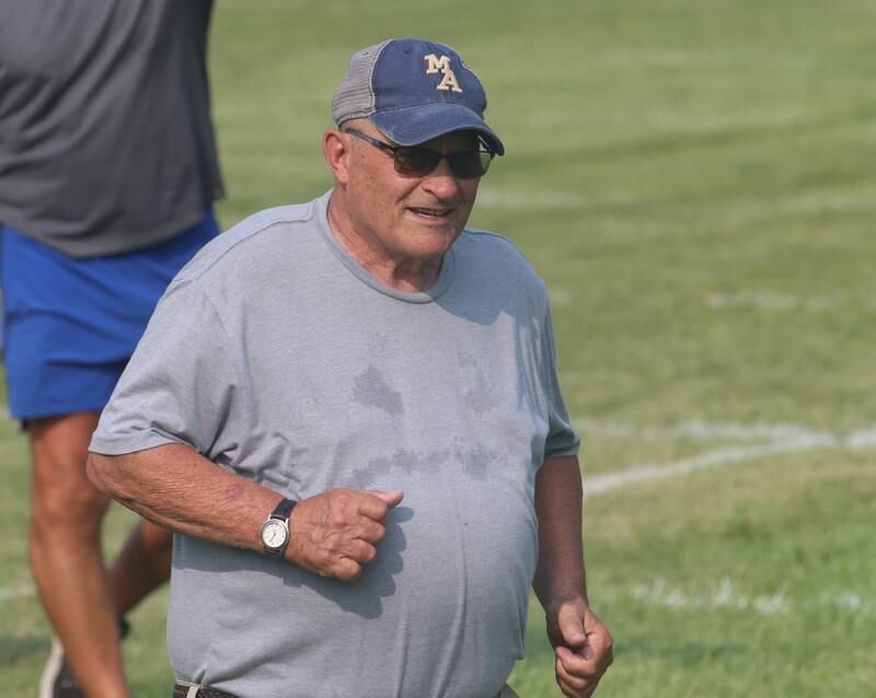 Marquette head football coach Tom Jobst runs with his football team during football camp on Monday, July 24, 2023 on the practice field next to Gould Stadium in Ottawa.