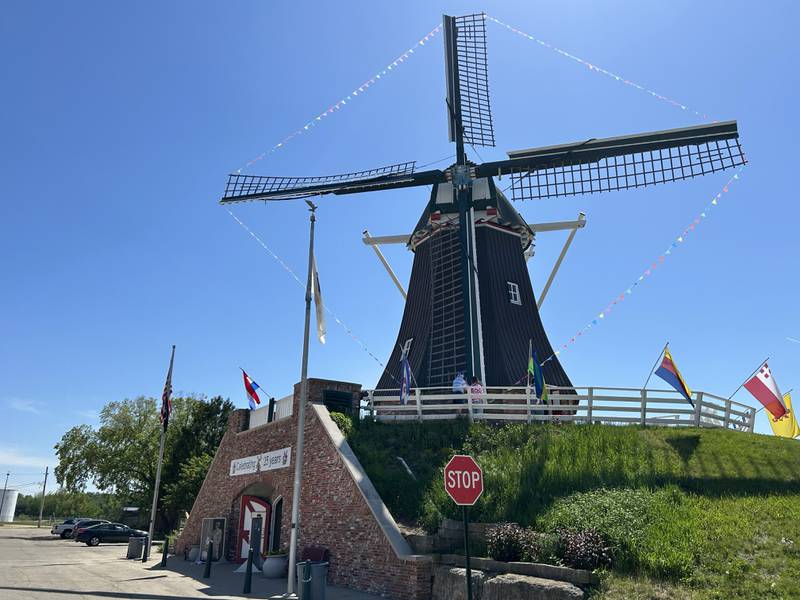 Visitors tour the de Immigrant Windmill in Fulton as it stands out against a clear blue sky on Sunday, May 11, 2025. The unique attraction is open Saturdays from 10 a.m. to 5 p.m. and Sundays from 1-5 p.m. The Windmill Cultural Center is  located across the street from the windmill.