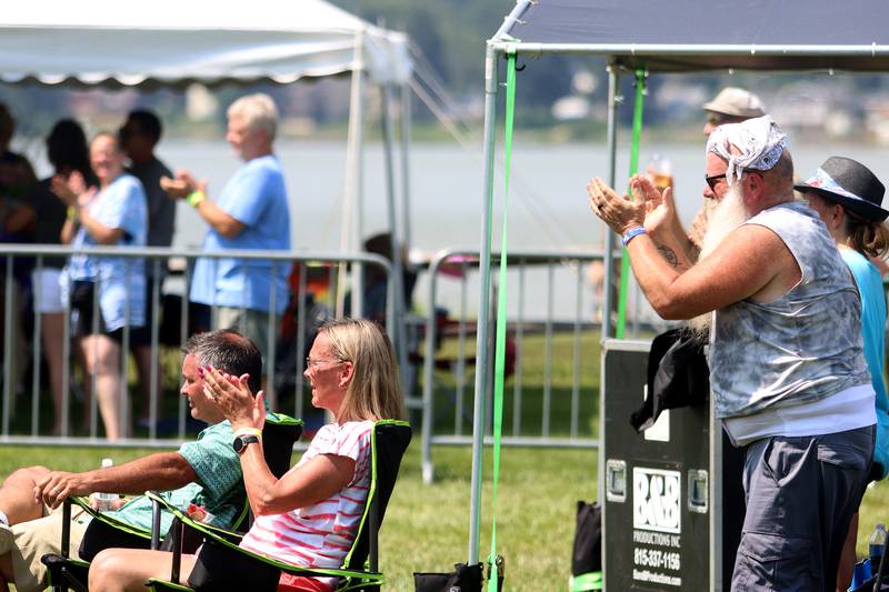 People cheer for the Wall of Denial Band during the final day of Bands,  Brews, and BBQ at McHenry’s Petersen Park Sunday.