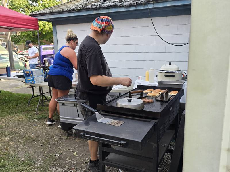 Aces & Eights Bar prepares grilled food to sell Saturday, Aug. 24, 2024, at Tonica Fest.