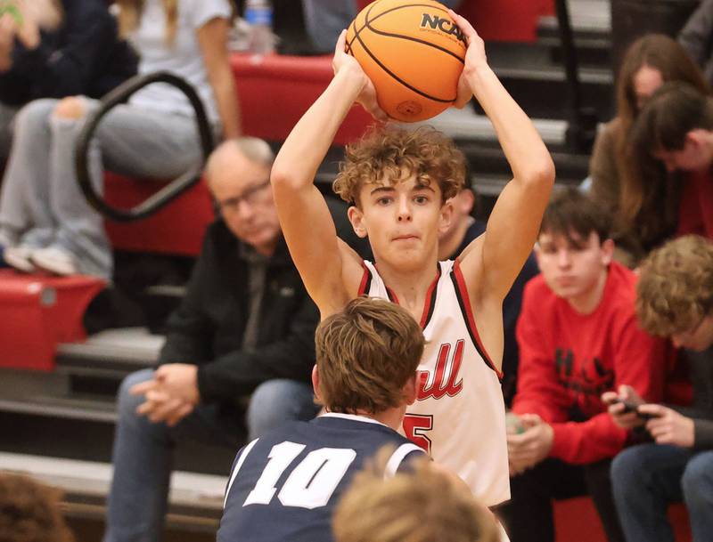 Hall's Jacob Andracke looks to pass the ball over the top of Fieldcrest's Kash Klendworth during the Colmone Classic on Friday, Dec. 12, 2025 at Hall High School.