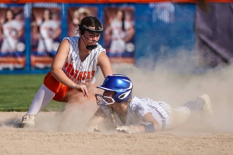 Oswego’s Kennedy Gengler (9) tags Wheaton North's Makayla Hammer (11) for an out during a Class 4A Oswego Sectional Final game at Oswego High School on Friday, June 6, 2025.