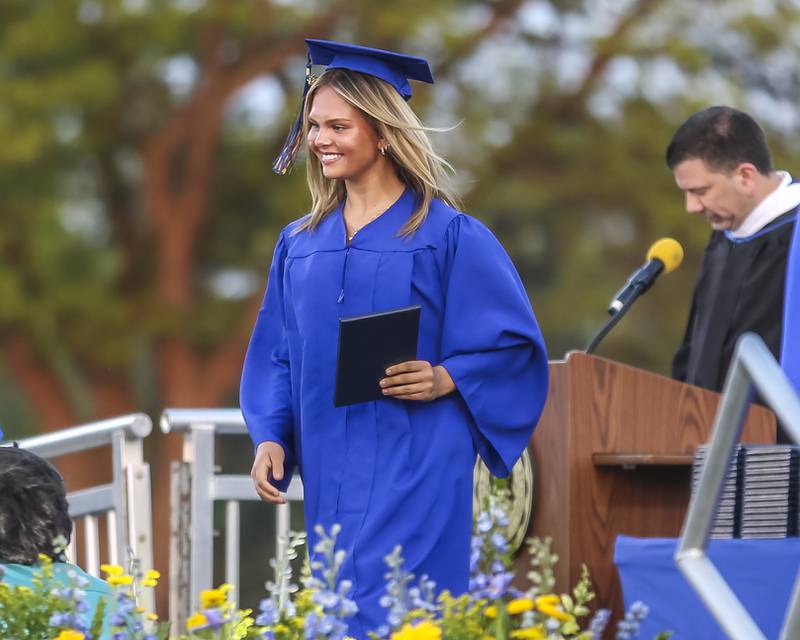 A student heads to her seat after receiving her diploma at the Lyons Township High School Graduation ceremony Wednesday, May 28, 2025  in Western Springs.