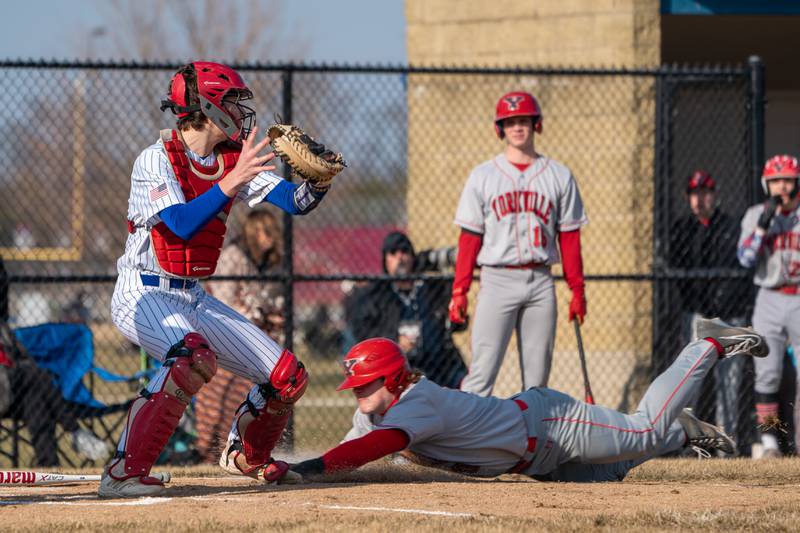 Yorkville's Kam Yearsley (17) slides into home to avoid the tag from Marmion’s Dylan Ayres (13) for a score against Marmion during a baseball game at Marmion High School in Aurora on Tuesday, Mar 28, 2023.