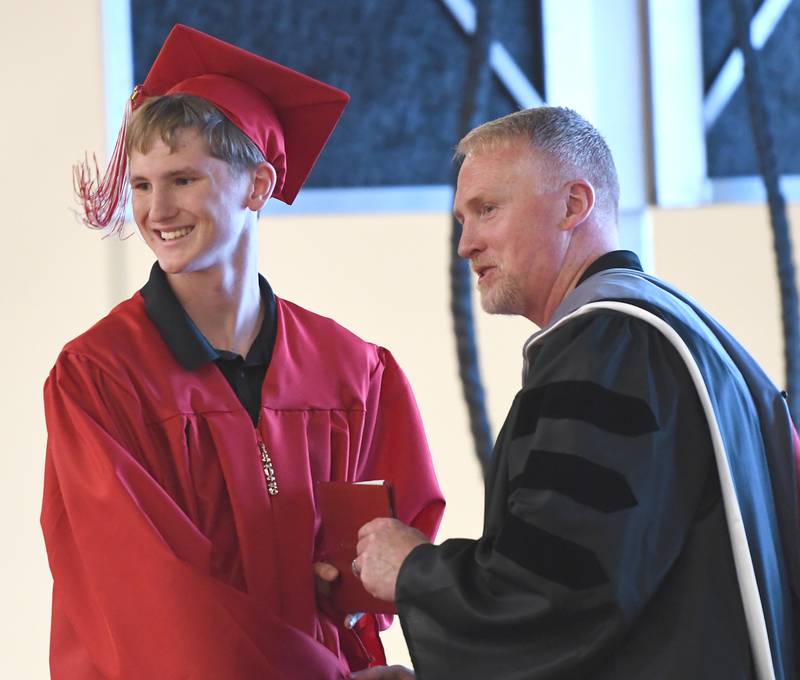 Oregon High School graduate Noah Near receives his diploma from school board president Bryan Wills during the Class of 2026 commencement ceremony on Sunday, May 24, 2026.