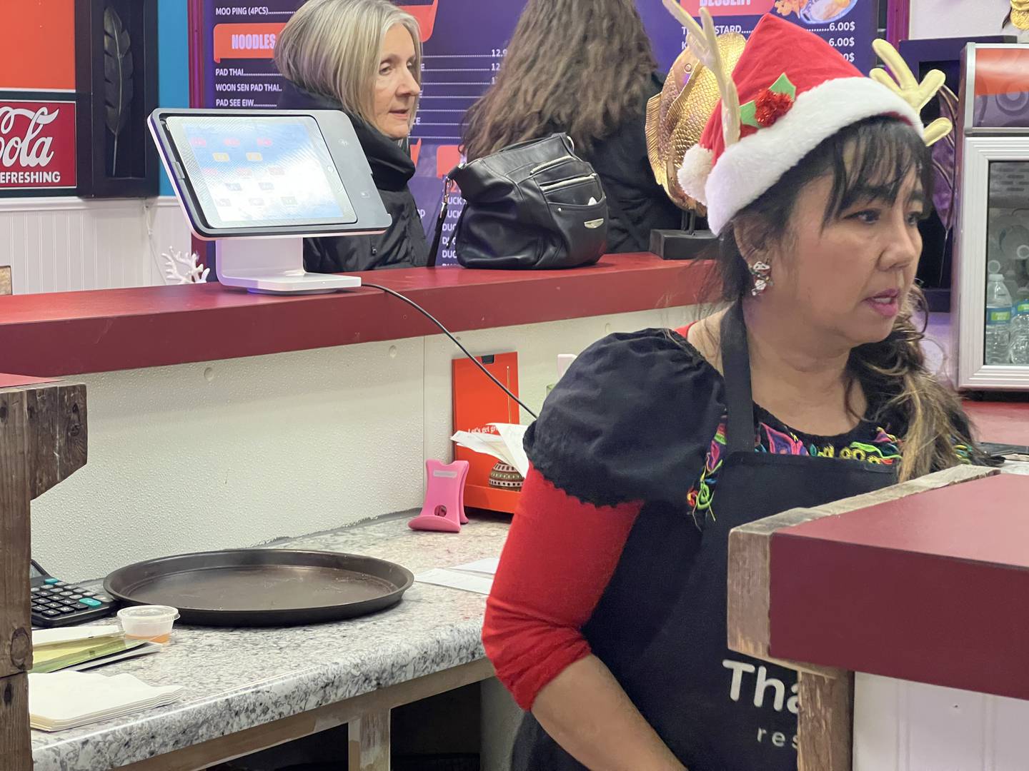 Kalayakorn Bogaert, co-owner of Thai Town, 630 Plaza Drive in Sycamore, gathers orders as patrons wait to sample the city's newest restaurant on Dec. 13, 2023.